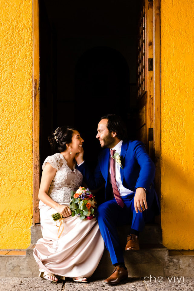 Couple laughing together sitting at the door