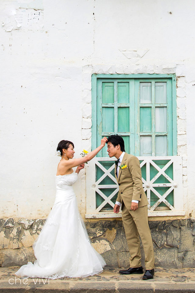 Bride give a gentle touch to groom's hair