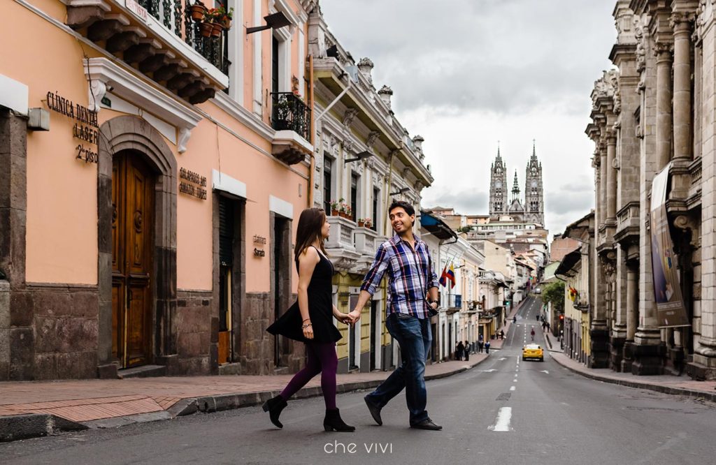 Couple walking on the street Basilica Church on the bacground Quito Ecuador engagement photos.