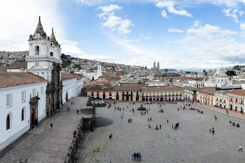 Vista panorámica de la Plaza Grande y la Catedral de Quito bajo un cielo nublado. El corazón histórico de Ecuador como testigo de una pedida de mano clásica.